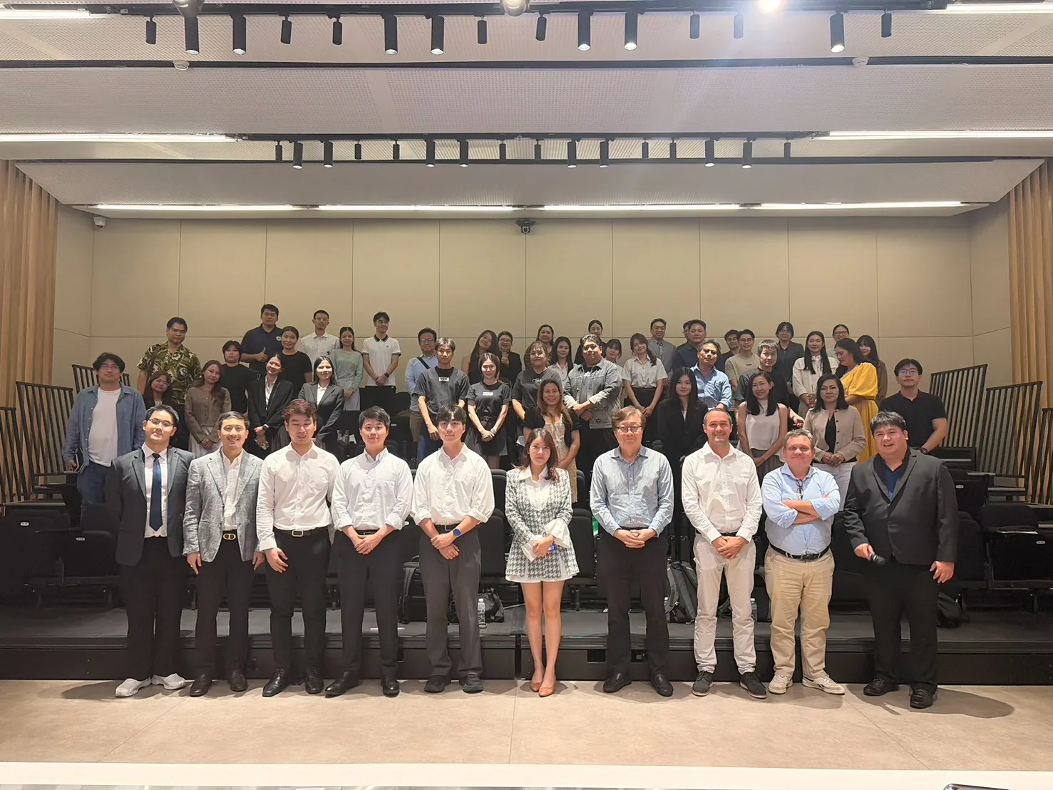 Speakers and attendees in a group photo at the close of TIA 2026